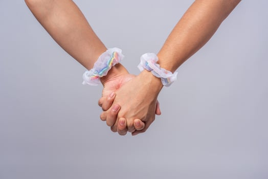 Two men who love each other stand hand in hand. photo