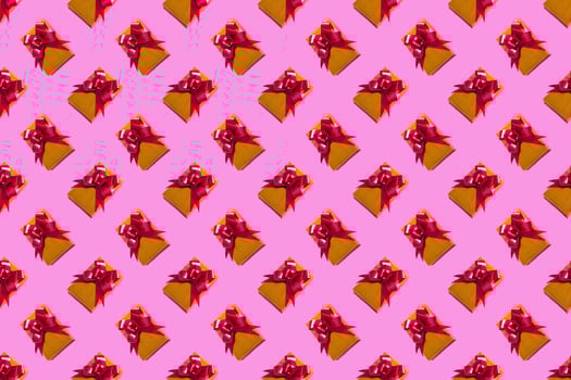 New Year Christmas composition. Gold gift with a red bow on a pink background. Top View Copy Space New Year 2022 Christmas photo