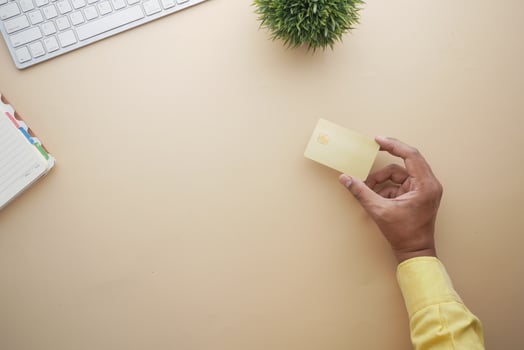 close up of person hand holding credit card photo