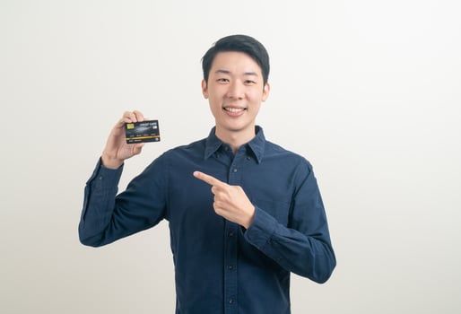 young Asian man holding credit card photo