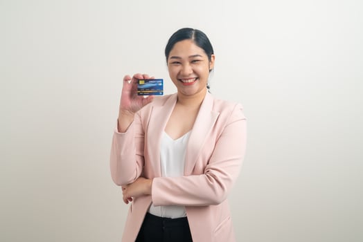 Asian woman holding credit card with white background photo