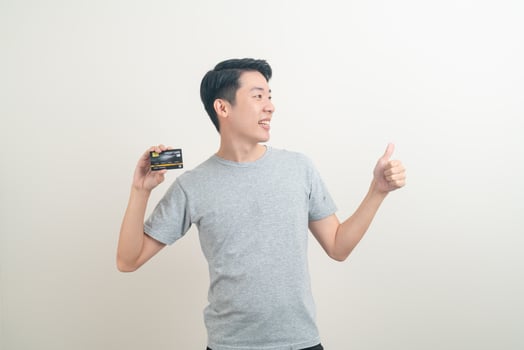young Asian man holding credit card photo