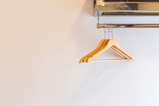 Wooden Three luxury coat hanger on brick wall inside the hotel bedroom interior. photo