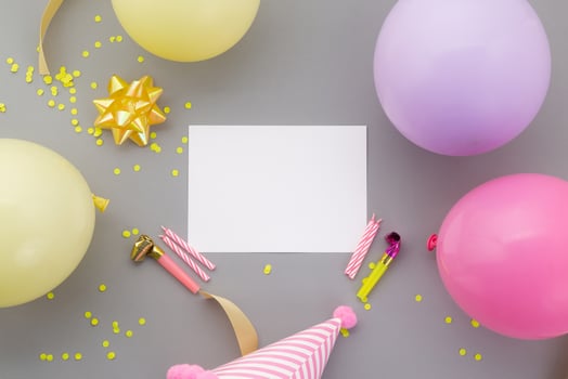 Happy birthday background, Flat lay colorful party decoration with flyer invitation card on pastel grey background photo
