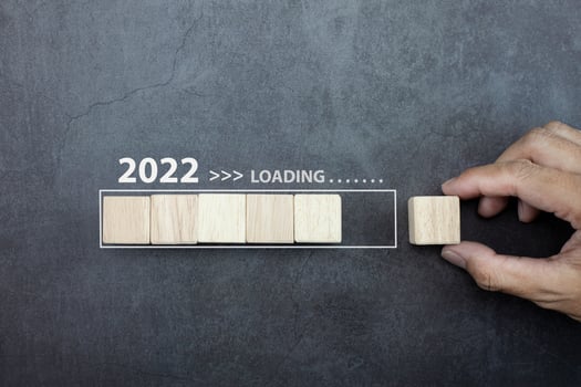 Loading new year 2022 concept, hand man putting cube wooden on process bar. photo