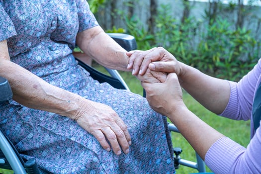 Caregiber holding hands Asian senior or elderly old lady woman patient with love, care, encourage and empathy at nursing hospital ward, healthy strong medical concept photo