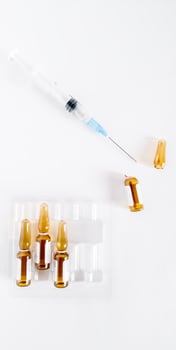 Syringe with medicine and ampoules on a white background. photo
