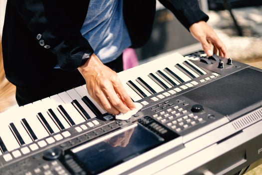 Part of a man's hand playing the piano photo