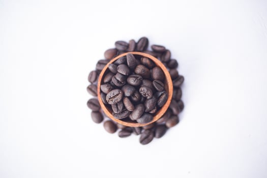 coffee beans on a wooden bowl with circle shape photo
