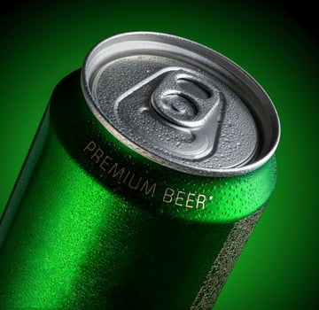 Can of beer with drops of water in a green background with illumination. Advertising of beer photo