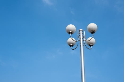 A street lamp composed of four round bulbs under the blue sky photo
