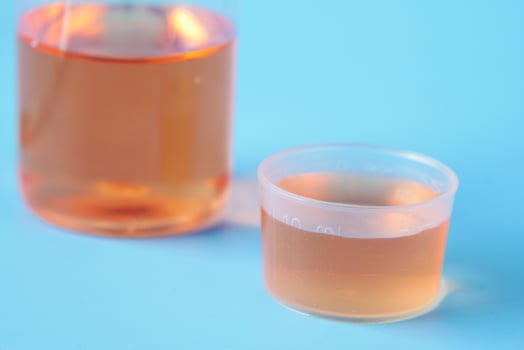 bottle with liquid medicine on white , photo