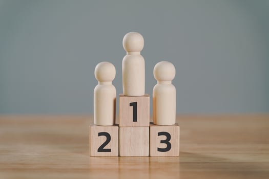 wooden figures peg doll standing on the podium 1st, 2nd, 3rd positions of wooden cube blocks with copy space. ranking and strategy concept. photo