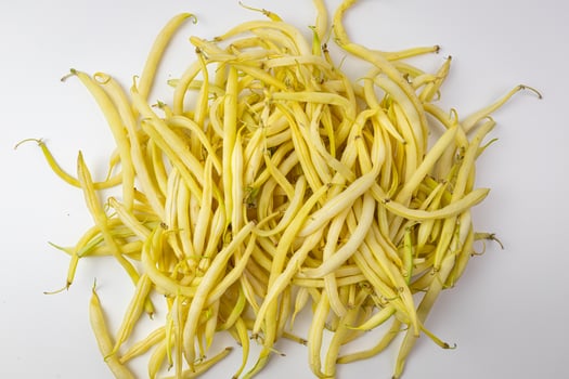 Yellow green beans on a white background. Top view. photo