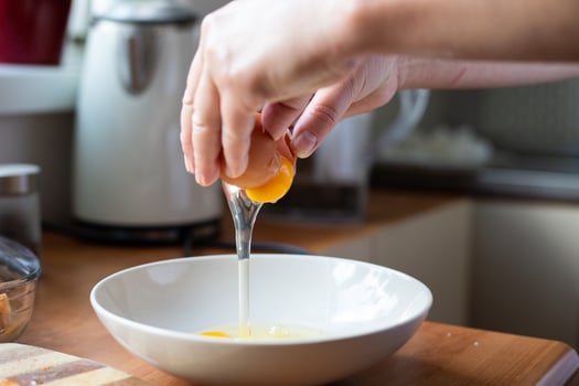 Egg broken into a bowl. Preparation of ingredients for breading. photo