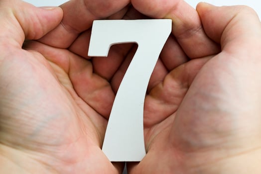 Hand holding number seven. photo