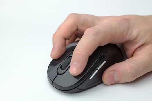 Hand holds a computer mouse. photo
