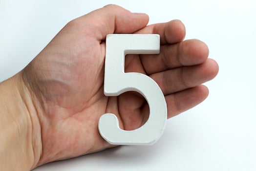 Hands holding five digit. photo