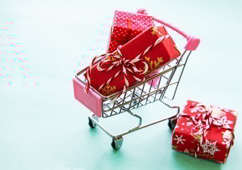 Shopping cart with gift boxes photo