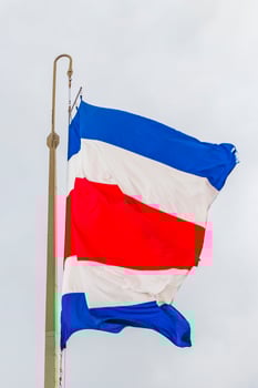 Flag of Costa Rica cloudy white sky Costa Rican flag. photo