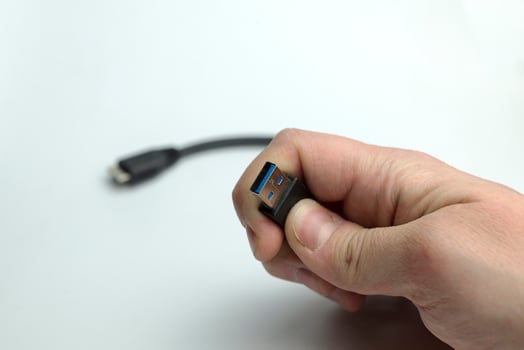 Hand holds usb cable photo