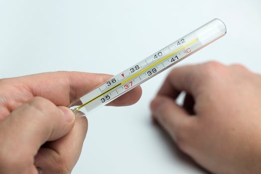 Hand holds a thermometer. photo