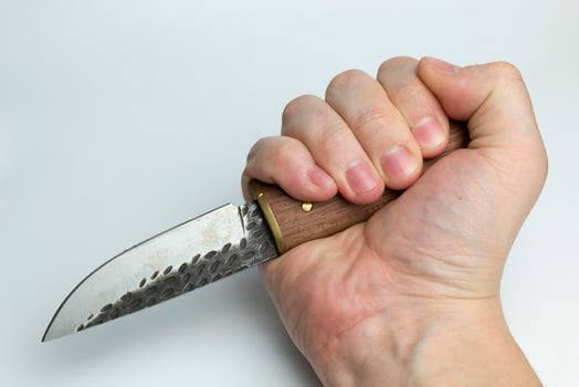 Hand on a white background holding a knife. photo