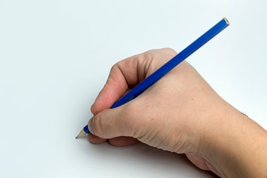 Hand on a white background holding a pencil. photo