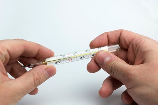 Hand holds a thermometer. photo
