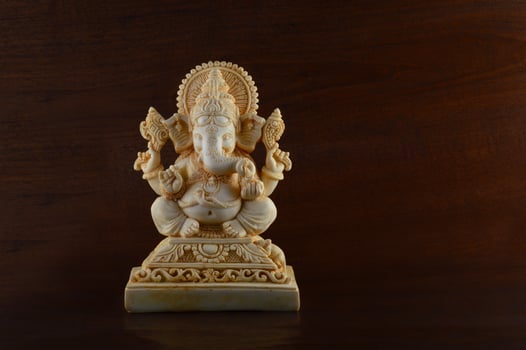 Hindu God Ganesha. Ganesha Idol on brown background photo