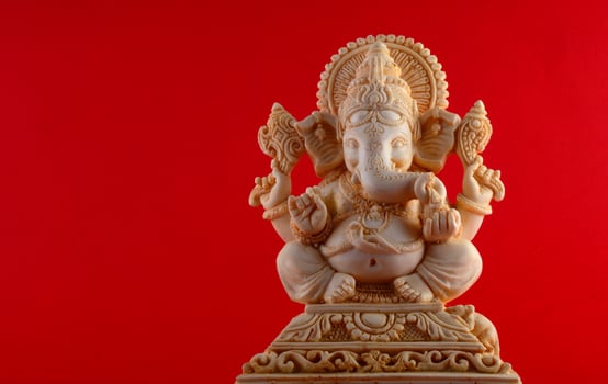 Hindu God Ganesha. Ganesha Idol on red background photo