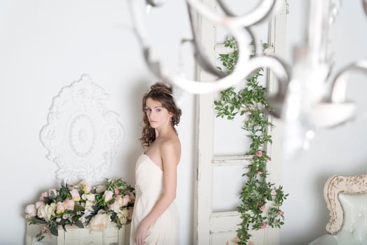 Girl in a white dress with flowers in the house. photo