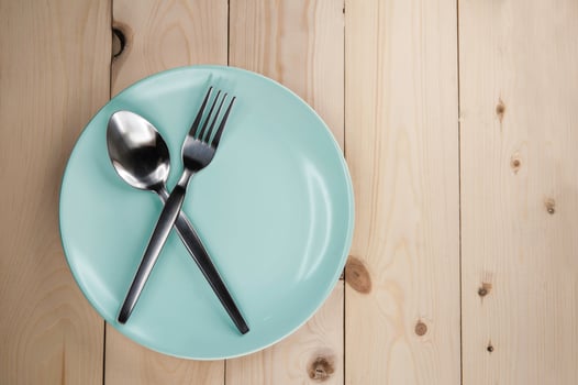 Plate and cutlery on wooden table photo