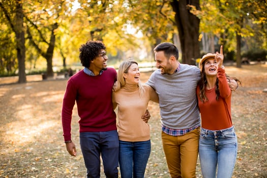 Multiracial young people walking in the autumn park photo