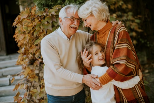 Grandparents enjoying good time with their little granddaughter photo