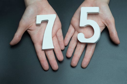 To female hands the figure of seventy-five. photo