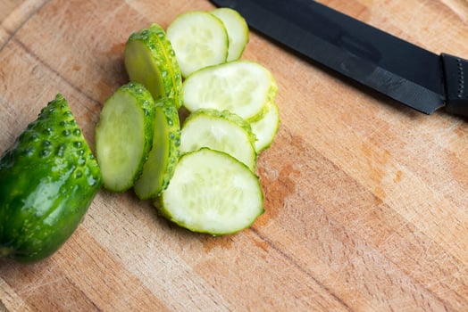 Green cucumber on a cutting Board. photo