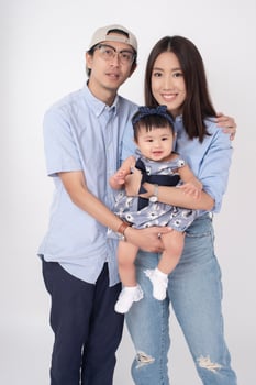 Happy Asian family on white background photo