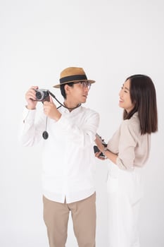 Asian couple tourists are enjoying  on white background photo