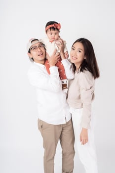 Happy Asian family on white background photo