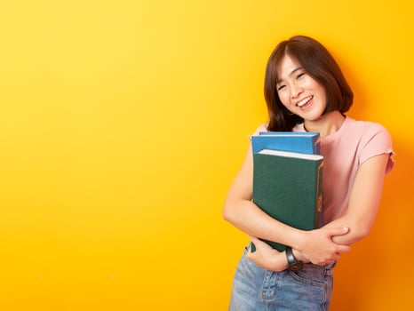 Beautiful asian woman University student happy on yellow background photo