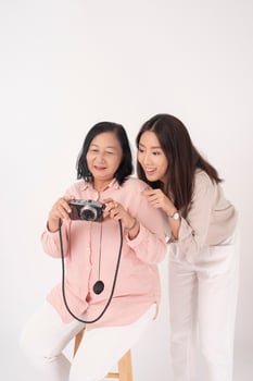 Asian older woman and her daughter on white background, Travel concept photo