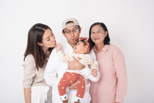Happy Asian family on white background photo