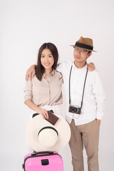 Asian couple tourists are enjoying  on white background photo