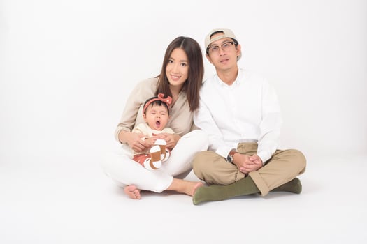 Happy Asian family on white background photo