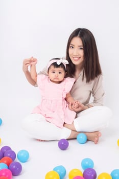 Asian mother and adorable baby girl are  happy on white background photo