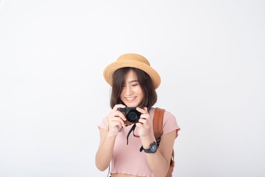 Beautiful young asian tourist woman happy on white background studio photo