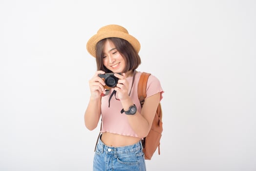 Beautiful young asian tourist woman happy on white background studio photo