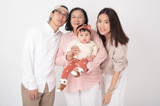 Happy Asian family on white background photo