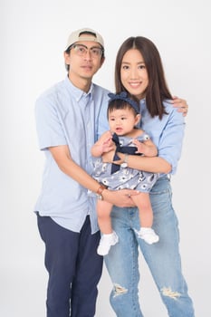 Happy Asian family on white background photo